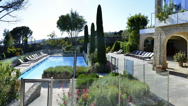 A pool area with lounge chairs, stone walls, and potted plants. - Charming Bastidon with Terrace, Garden, and Pool in Gordes, Luberon  (Gordes)