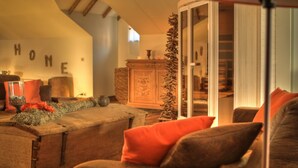 A cozy living room with a fireplace, a sofa, and a cabinet. - house with private pool, jacuzzi, sauna, hammam for 4 adults, 2 children (Theux)