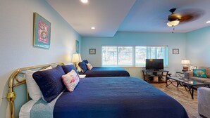 A hotel room with two beds, a television, a desk, and a window with blinds. - Shared Pool, Walk Path to Beach, Golf Cart Access (Port Aransas)
