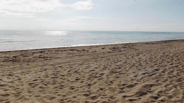 A sandy beach with footprints leading to the water. - Beach Cottage, Steps to Beach. Updated and Great Deal for Money. Pet Friendly. (Fort Pierce)