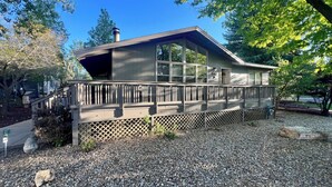 A modern house with a deck, large windows, and a chimney. - Amazing 5 Star Home, Amenities Galore, AC, no pet fee, 7 miles to NAU (Flagstaff)