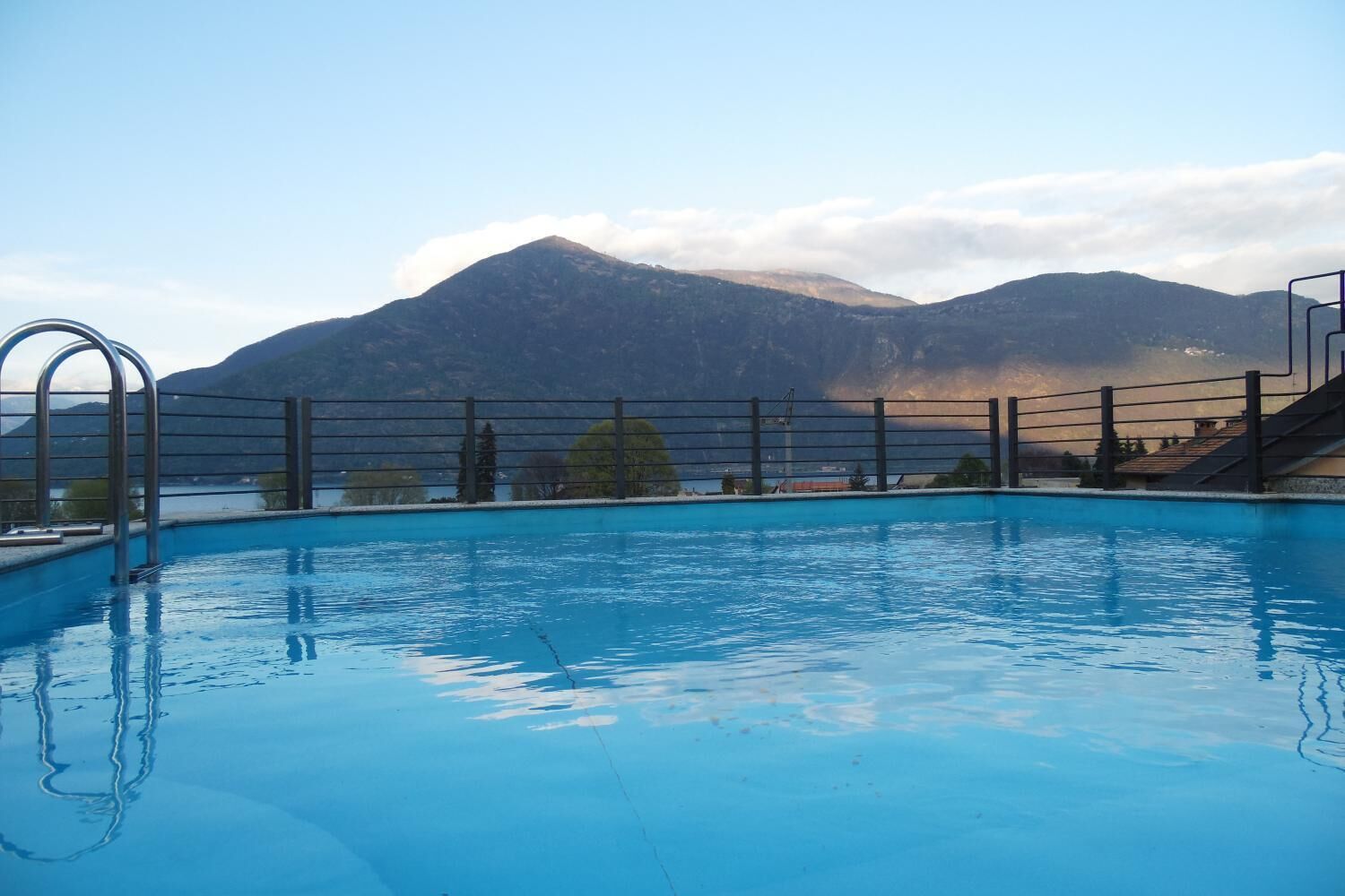 A swimming pool with a view of mountains in the background.