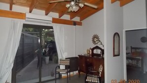 A room with a ceiling fan, a desk with a chair, a mirror, and a window with curtains. - El Fresno (Mendoza)
