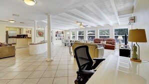 A spacious living area with a kitchen in the background, a dining table, and a sofa. - Delray Home W/Pool-Close To Beach & Downtown Atlantic Ave-Fun Tiki Hut-Bike-WiFi (Delray Beach)