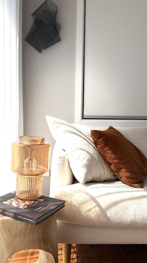 A neatly arranged room with a bed, a side table with a lamp, and a framed picture on the wall. - Culburra Retreat - Newly Renovated, Pet Friendly, 4 Min Walk to the Beach (Culburra Beach)