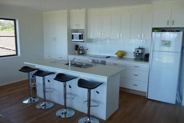 Open plan kitchen with dishwasher and coffee machine makes entertaining a breeze