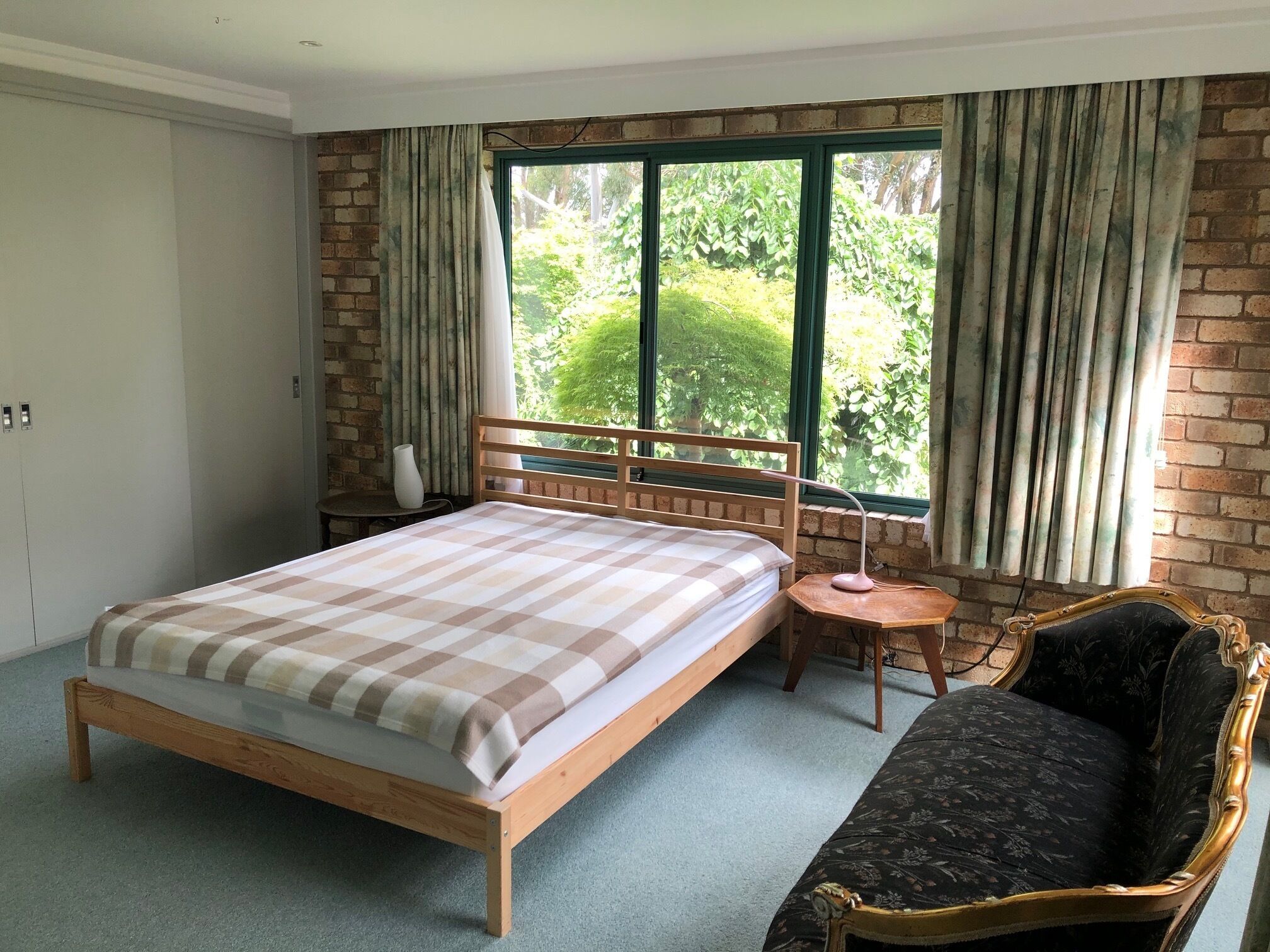 The second bedroom with a queen bed and access to the ensuite and deck. 