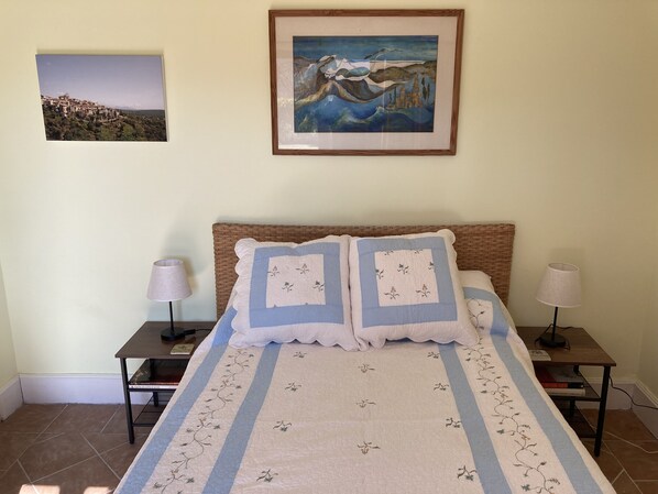 A bedroom with a bed, two bedside tables, two lamps, a framed painting, and a tiled floor. - Paradise in Provence- A Quiet Retreat (3BR) with Pool, Terrace, Barbecue, Garden (Tourrettes-Sur-Loup)