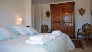 A bedroom with a large bed, two chairs, a wardrobe, and a mirror on the wall. - Discover the originality of CAP (P.M.R. access)7 pers (Sisco)