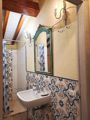 A bathroom with a sink, mirror, shower, and patterned tiles. - Cozy rustico on Versilia green hills, sea view, air cond, WIFI, 12 km sea, Lucca (Montigiano, Massarosa)