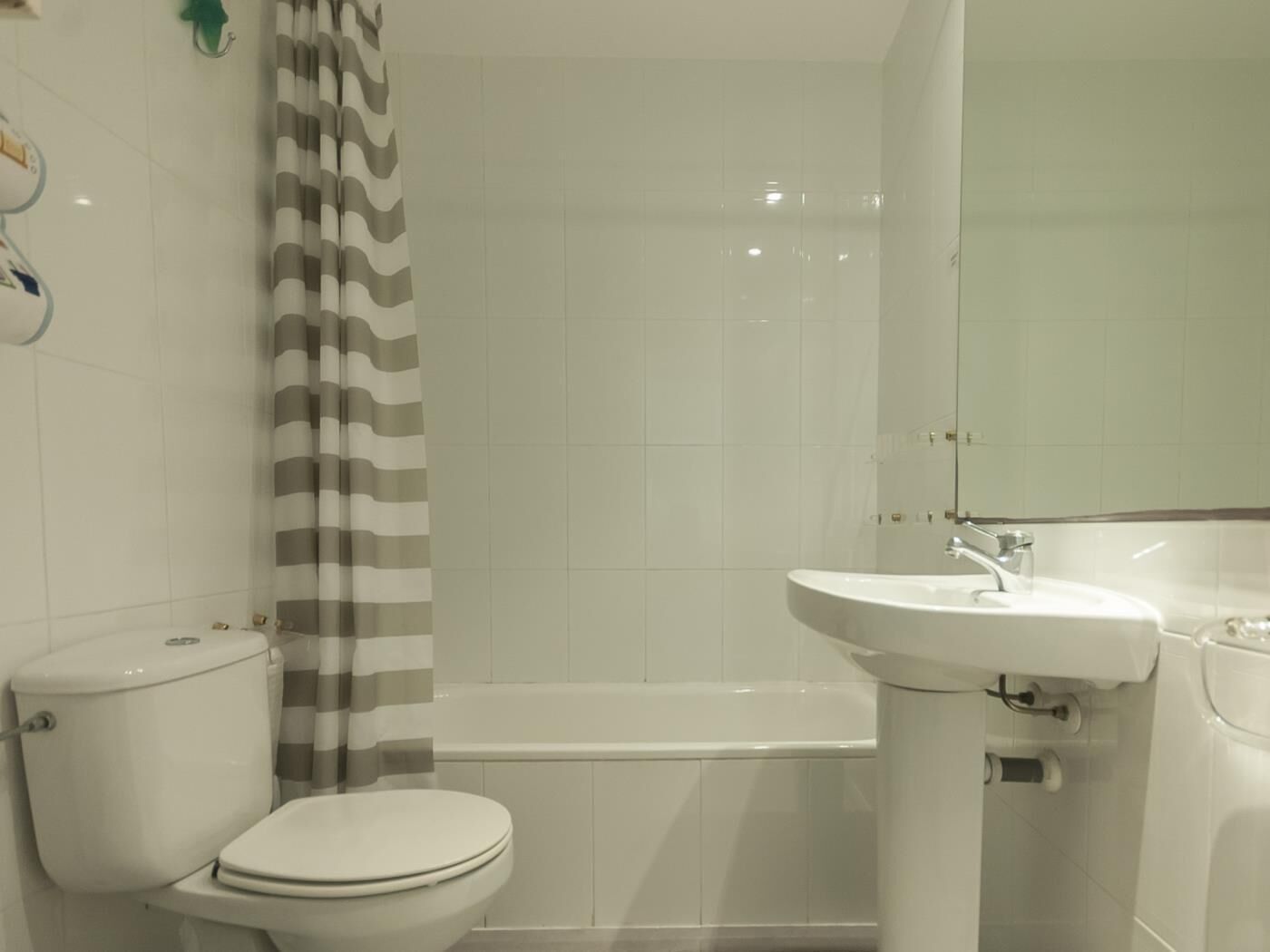 A bathroom with a toilet, a sink, and a bathtub.