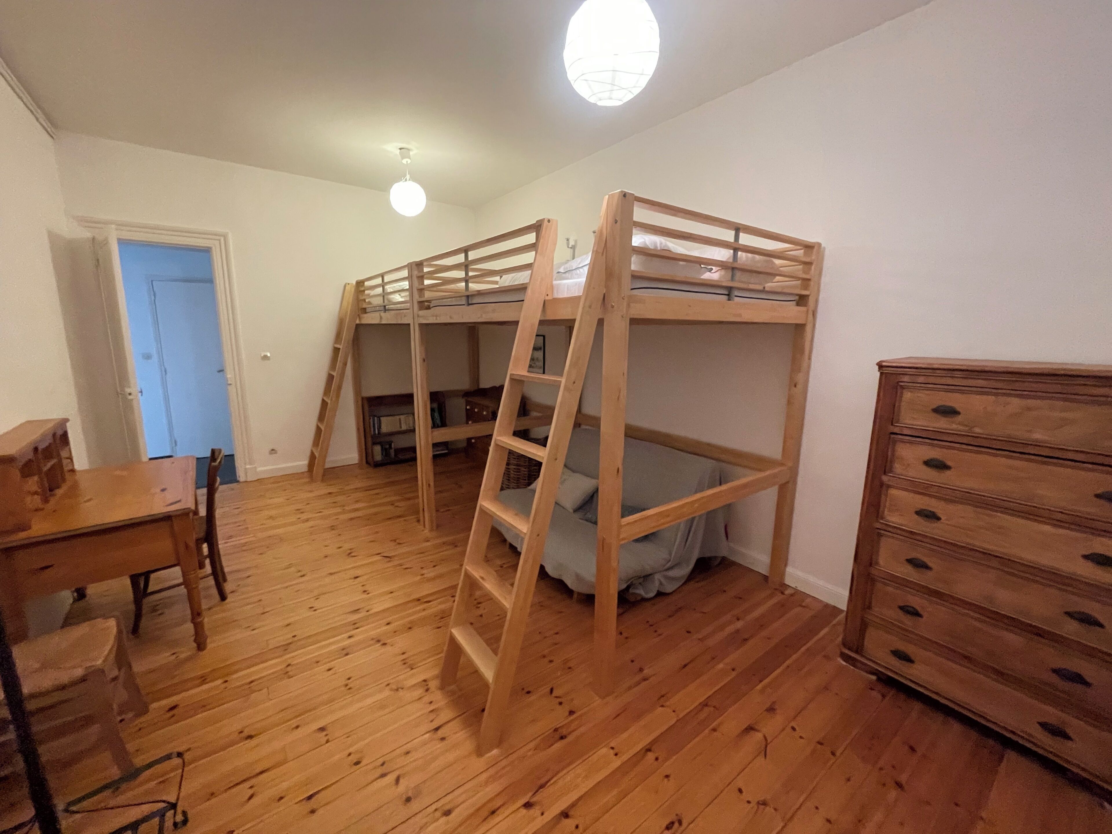 A room with a bunk bed, a dresser, a desk, and a chair.