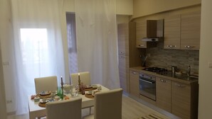 A modern kitchen with wooden cabinets, a gas stove, and a built-in oven. - Fantastic Penthouse in the center of Rome not far from the Vatican (Roma)