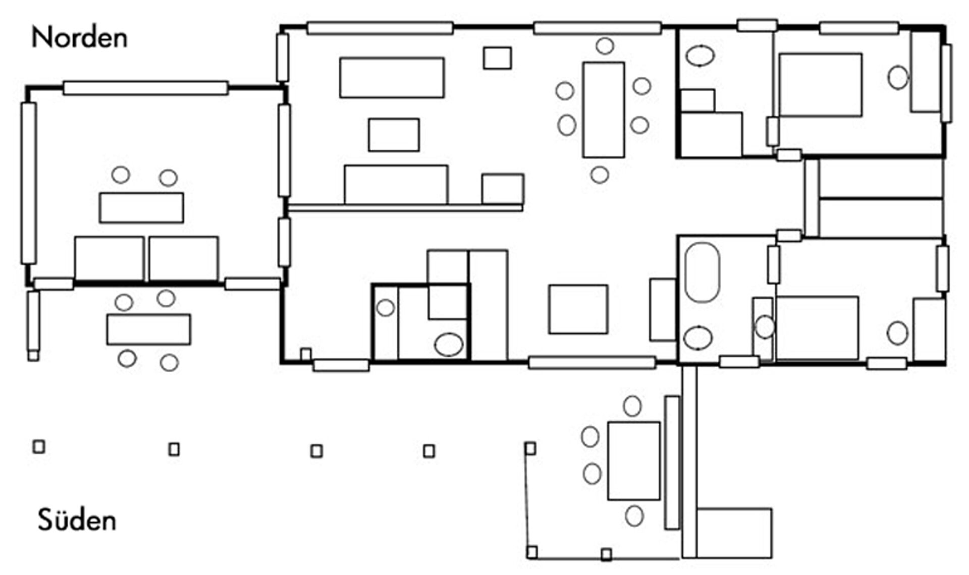 A floor plan with multiple rooms, including a large central area with a fireplace, several smaller rooms, and a kitchen area.