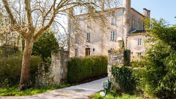 A historic stone building with a traditional architectural style, featuring a central entrance, multiple windows, and a chimney. - an unusual and Design Chateau (Pech- Luna)