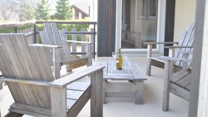 A wooden deck with four Adirondack chairs and a table, a bottle of wine, and a glass on the table. - Detached house 3 Bedrooms, 140 M2, Loggia, Balcony, private garden 800 M2 (Les Hôpitaux-Neufs)