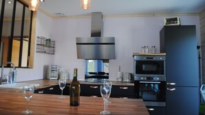 A modern kitchen with stainless steel appliances, wooden countertops, and pendant lighting. - Detached house 3 Bedrooms, 140 M2, Loggia, Balcony, private garden 800 M2 (Les Hôpitaux-Neufs)