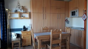 Enjoy a convenient kitchen with a dining table, microwave, and coffee maker.