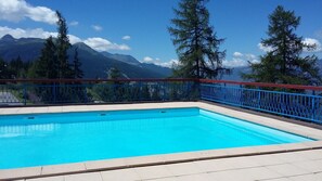 Relax by the pool with a breathtaking view of the surrounding mountains.