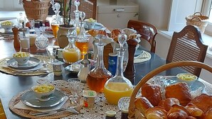 A dining table set with various dishes, drinks, and pastries. - Grand cru house (Chardonnay)