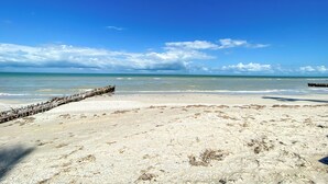 A beach with clear skies, calm waters, and a wooden jetty. - Summer and Fall Dates Available! (Cuburna, Progreso)