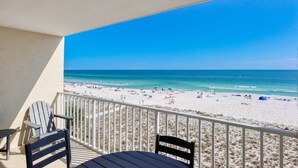 A balcony with a view of a beach and ocean. - Beachfront Family Condo w/ Balcony Views, Hot Tub, Pool & Great Rates (Gulf Shores)