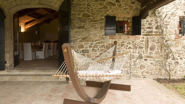 A stone building with a hammock in the foreground.