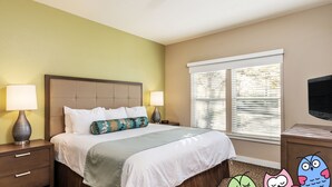 A hotel room with a bed, two bedside lamps, a TV, and a window with blinds. - Sip, Taste, Hot Tub, Repeat - Full Resort Access - Sleeps 6 (Windsor)