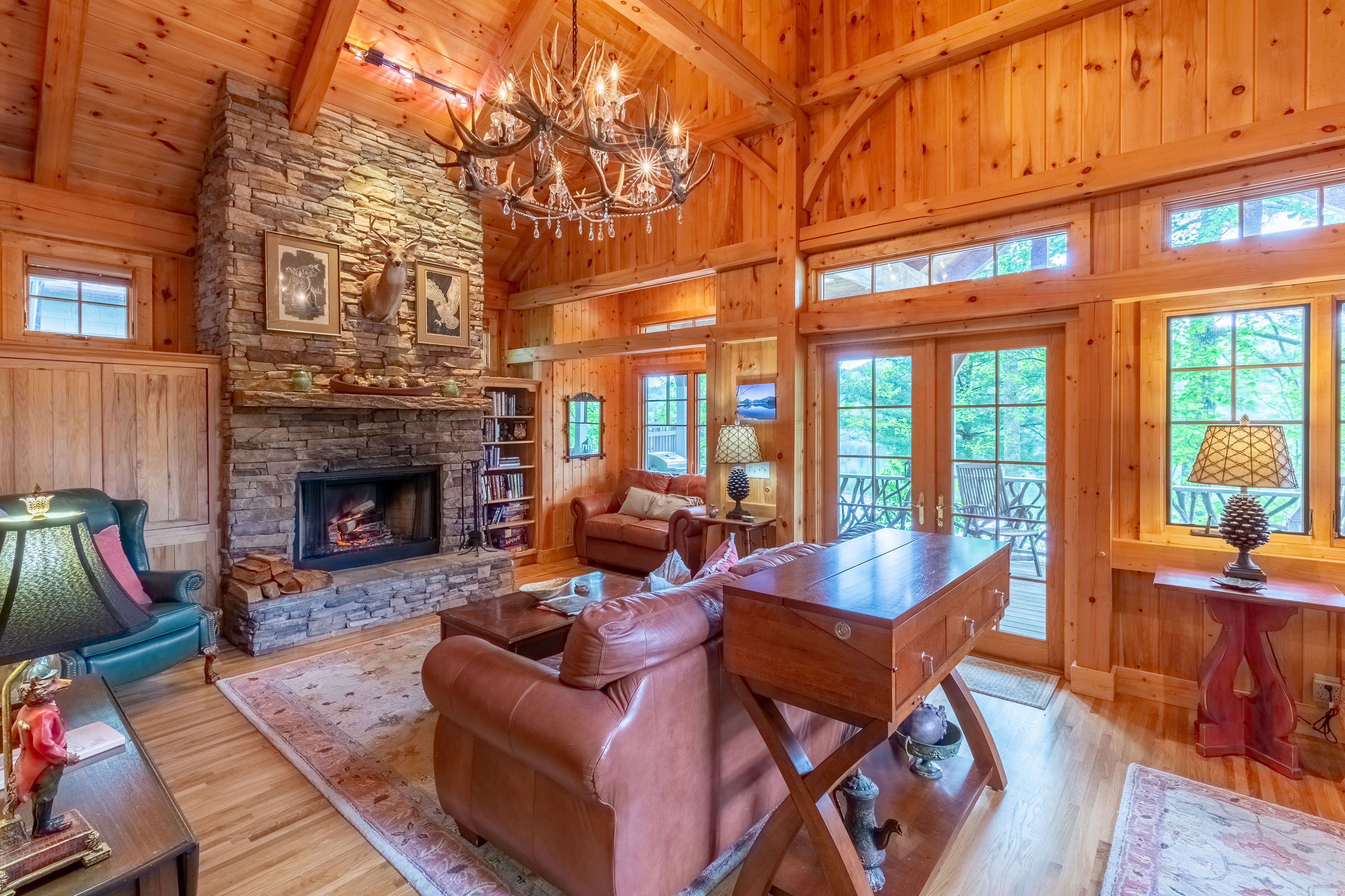 Great room with stone fireplace and French doors out to the upper level porch