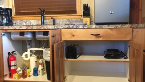 A compact kitchen with a built-in refrigerator, a coffee maker, and a toaster. - Close to Bear World , Heise Hot springs ,  West Yellowstone and Jackson Hole.  (Rexburg)