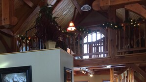 A cozy, rustic interior with a wooden staircase, a large window, and a framed picture on the wall. - Close to Bear World , Heise Hot springs ,  West Yellowstone and Jackson Hole.  (Rexburg)