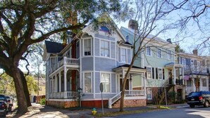 A row of Victorian-style houses with front porches and multiple stories. - Big Blue House - Lower Unit - Near Forsyth Park - Sleeps 8 (Savannah)