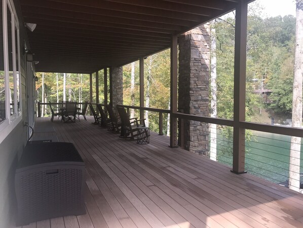 Relax on the covered deck with comfortable seating and take in the serene views of the surrounding water and forest.