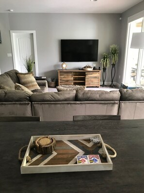 Relax in comfort with a sectional sofa, coffee table, and flat-screen TV in this cozy living space.
