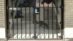 A gated entrance with a metal gate and a keypad lock. - Knights of Pythias Loft Downtown Albany, Oregon 2400 Sq Ft Of Space (ALBANY)