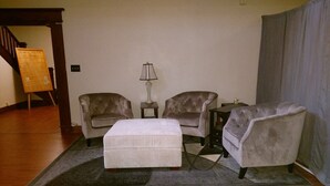 A living room with a sofa set, a coffee table, and a lamp. - Knights of Pythias Loft Downtown Albany, Oregon 2400 Sq Ft Of Space (ALBANY)