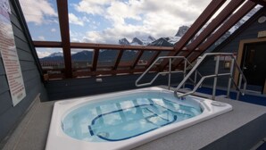 A hot tub with a view of mountains.