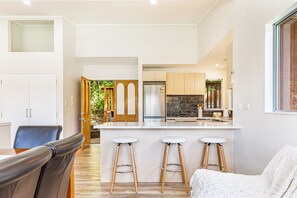 Prepare meals and socialize at the central island with bar stools, or dine at the wooden table and chairs.
