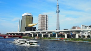 A river with a boat, a bridge, and modern buildings including a tower. - Hotel Trend Tobu Asakusa-Eki Kita (Tokyo)