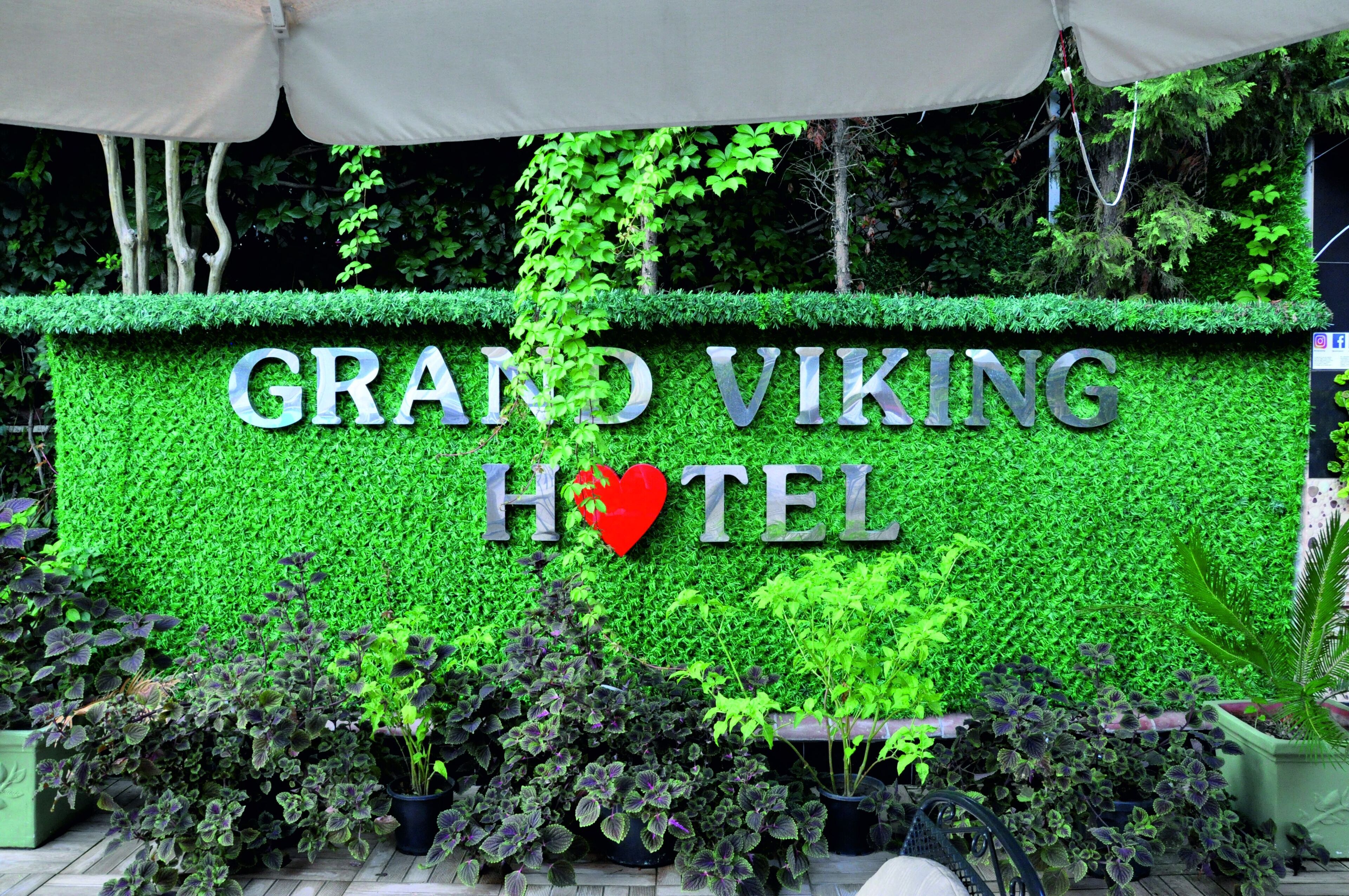 A sign for the Grand Viking Hotel with a heart symbol.