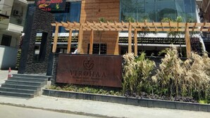 A modern building with a sign for 'VIROHAA Boutique Hotels & Apartments'.