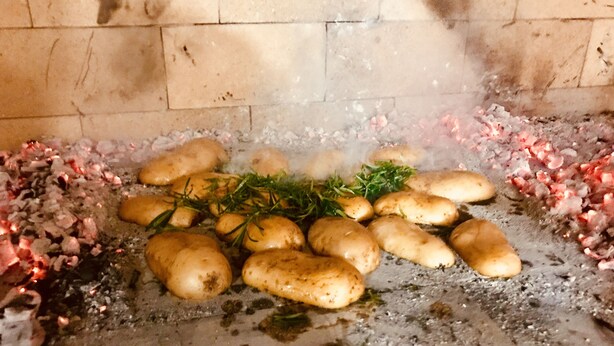 Potatoes cooking on a stove with a brick wall in the background. - Zlatni rat Beach Resort (Bol)
