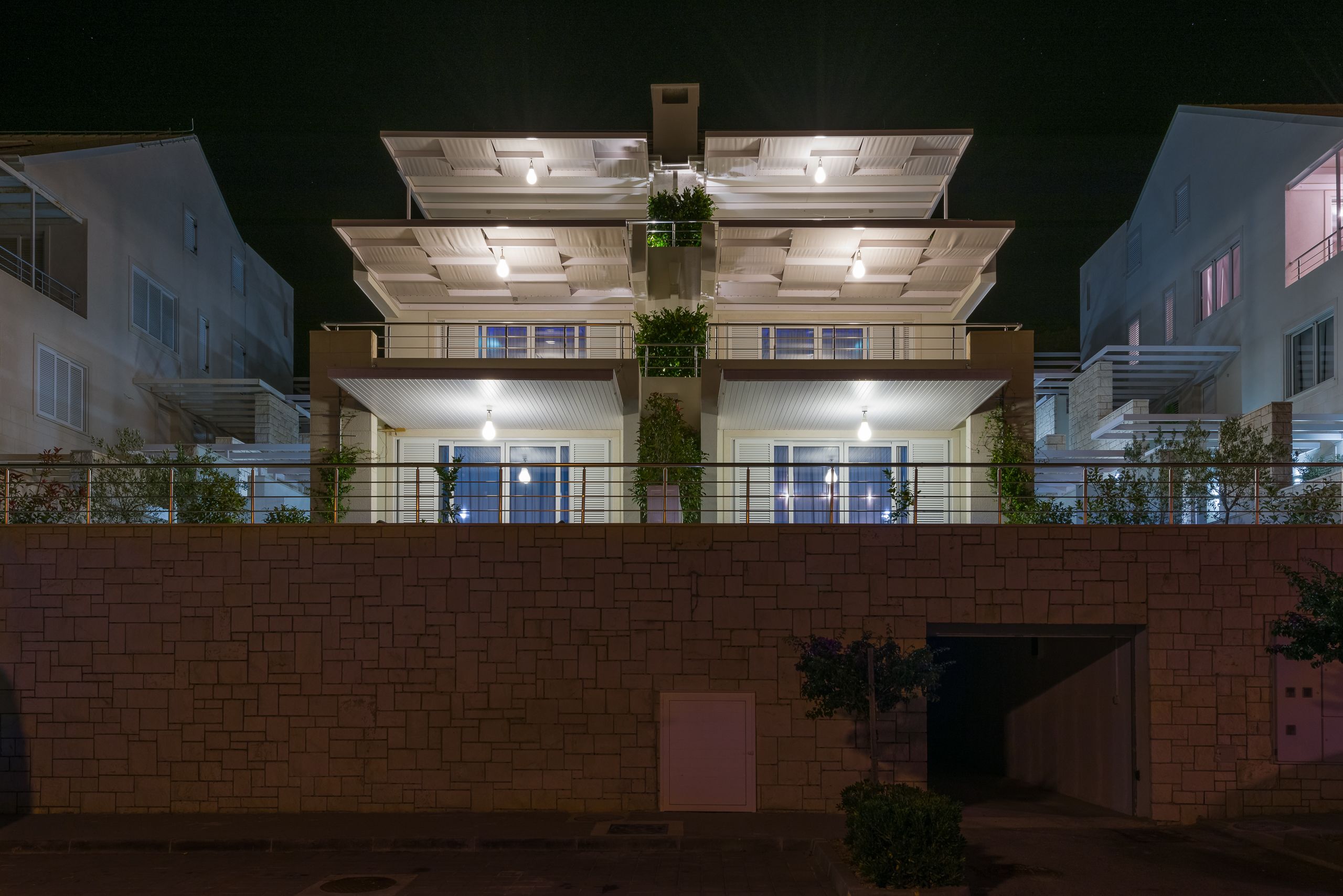 A multi-story residential building with balconies and a brick facade.