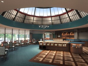 A spacious indoor area with a central island, seating arrangements, and a high ceiling with skylights. - Hotel Lorelei (Sasebo)