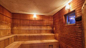 A wooden sauna with benches and a window.