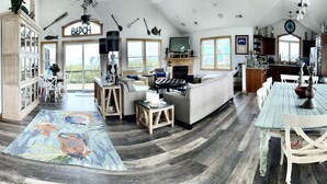 A spacious living area with a large window, a fireplace, and a dining table. -  360 views new outside, air purf, pool best beds always updating. Booking 2025 (Avon)
