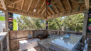 A wooden deck with a built-in barbecue area, a sink, and a window overlooking a green landscape. -  360 views new outside, air purf, pool best beds always updating. Booking 2025 (Avon)