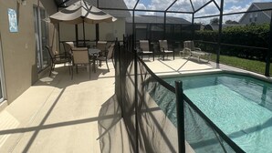 A covered outdoor area with a pool, chairs, and umbrellas. - Glenbrook Retreat-Come in as Guests and Leave as Friends (Clermont)