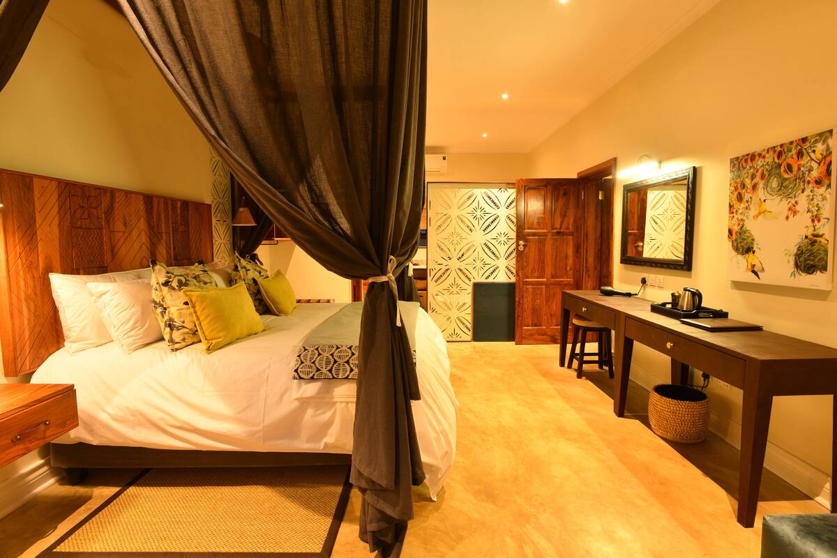 Un dormitorio con cama, escritorio y silla.