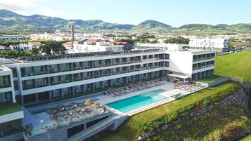 Indoor pool, outdoor pool, pool umbrellas, pool loungers